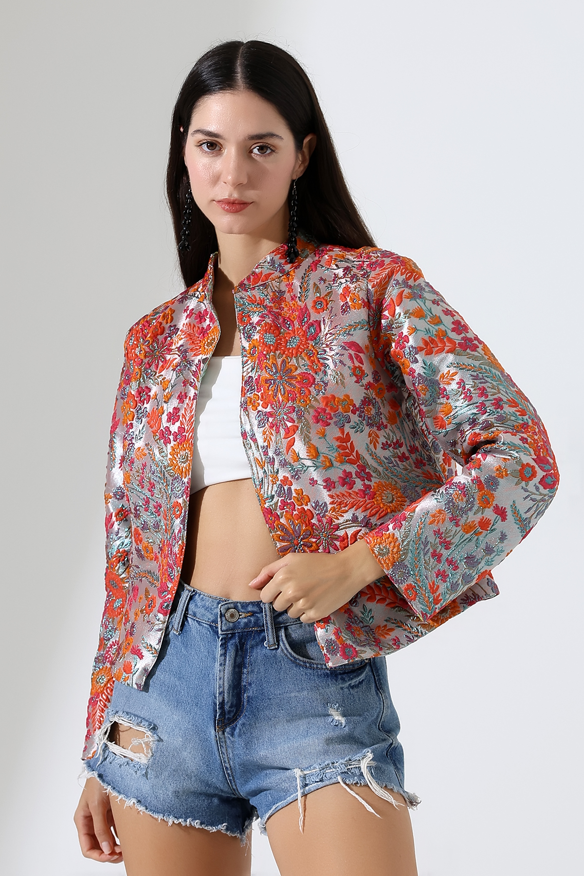 Model in sparkling evening jacket orange embroidered flowers